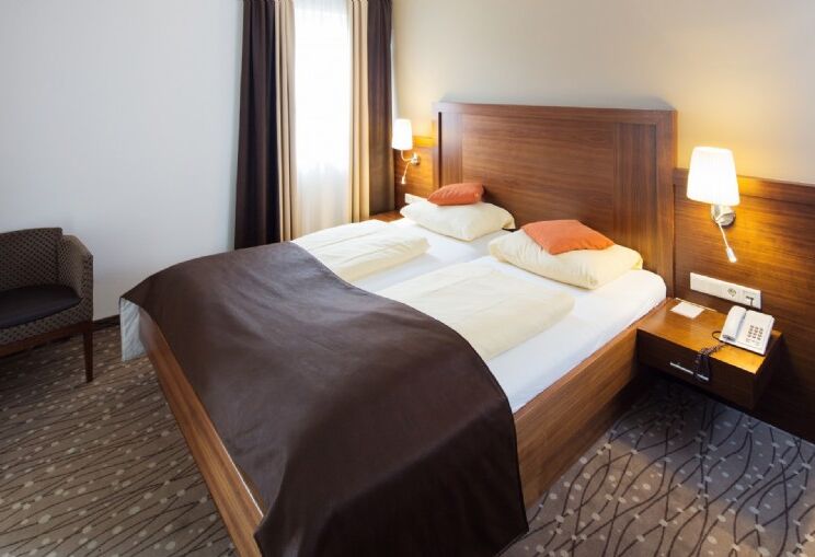 Double bed in a hotel room with a nightstand